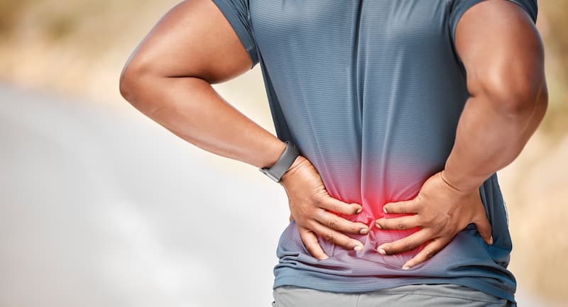Person experiencing low back pain associated with excess weight and increased spinal stress