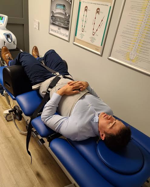 Chiropractor treating a patient with stress-related muscle tension through spinal adjustments and manual therapy