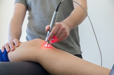 Patient receiving laser therapy for hip and knee pain to improve mobility and support natural healing